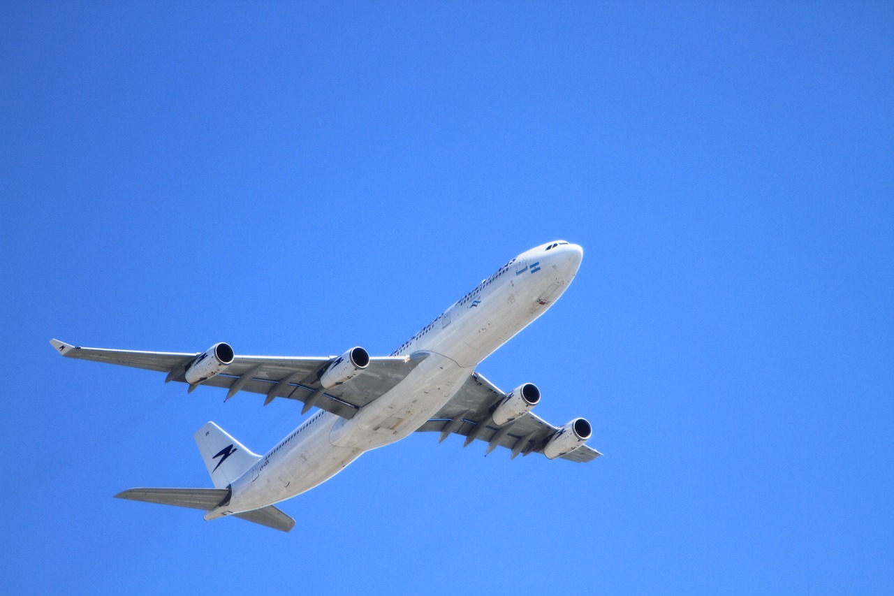 airplane flying blue sky