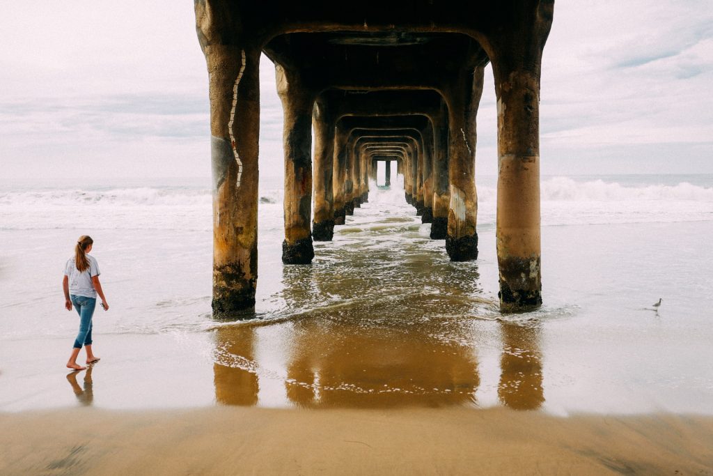 manhattan beach pier woman walking underneath picture example