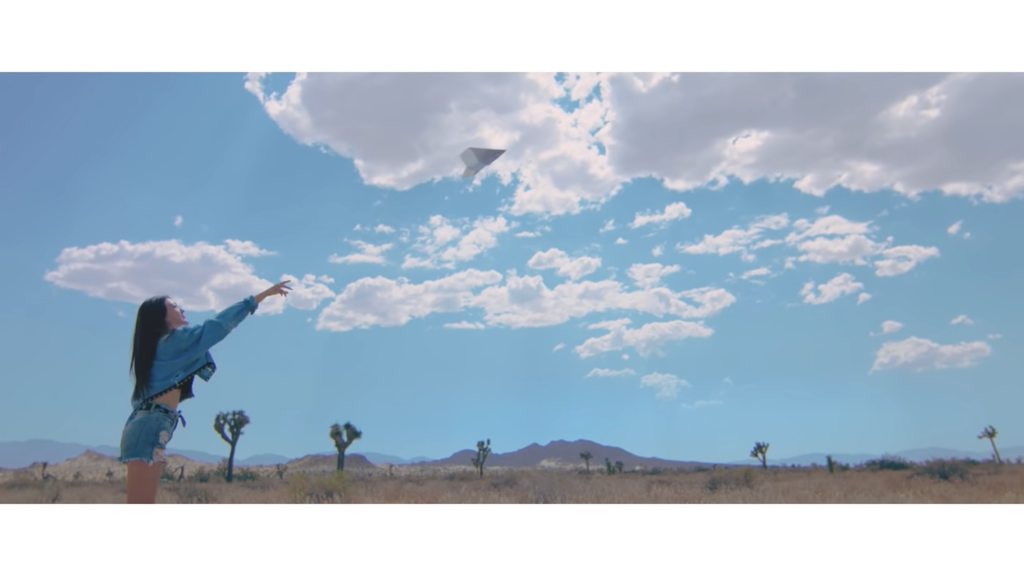 throwing airplane girl front loona joshua tree desert